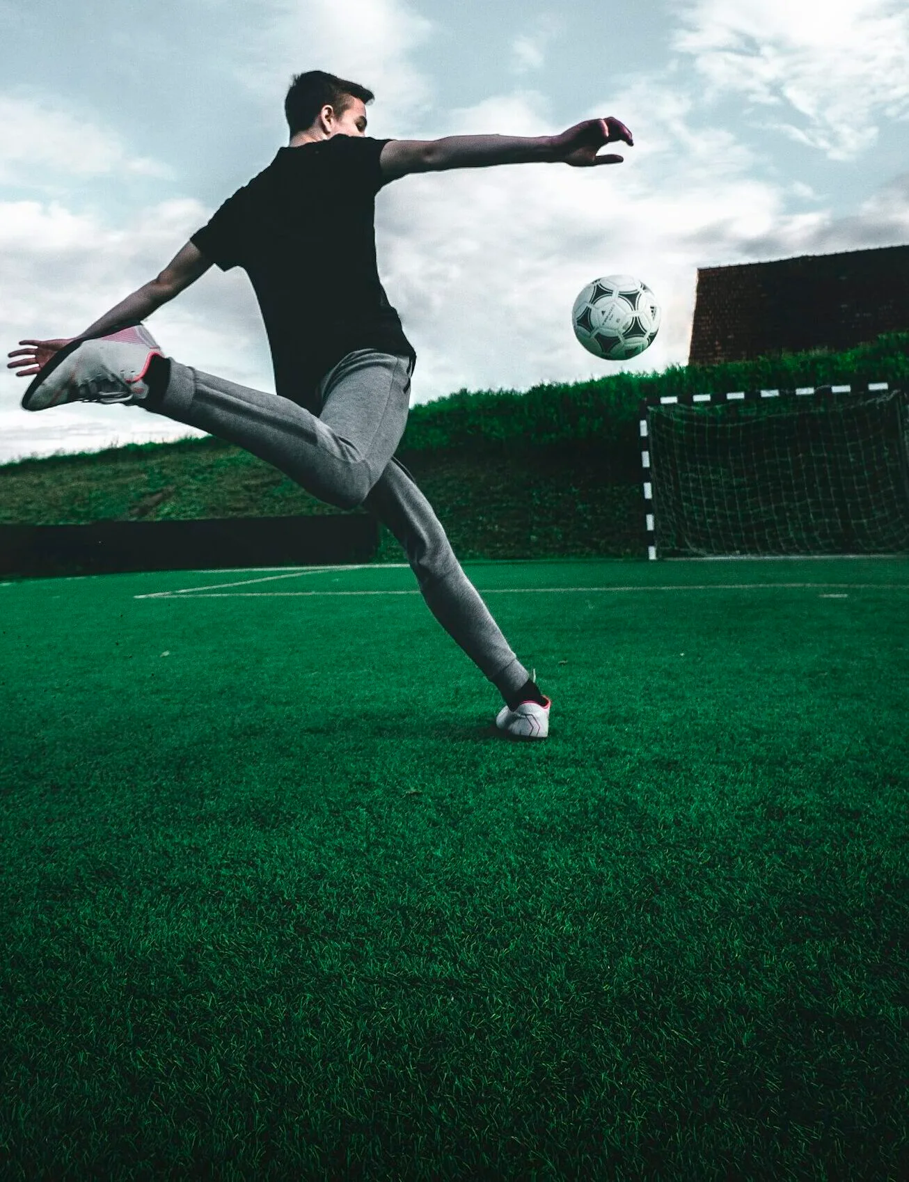 man playing soccer during daytime